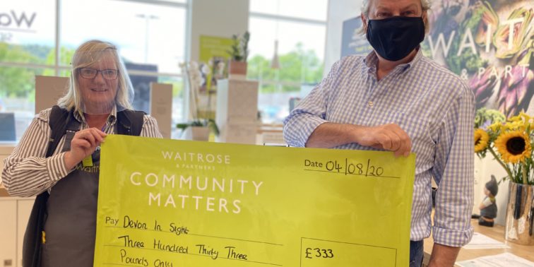 Julie Marish Community Lead Waitrose and Partners Sidmouth presenting Grahame CEO Devon in Sight with cheque as part of their Community Matters Campaign in May