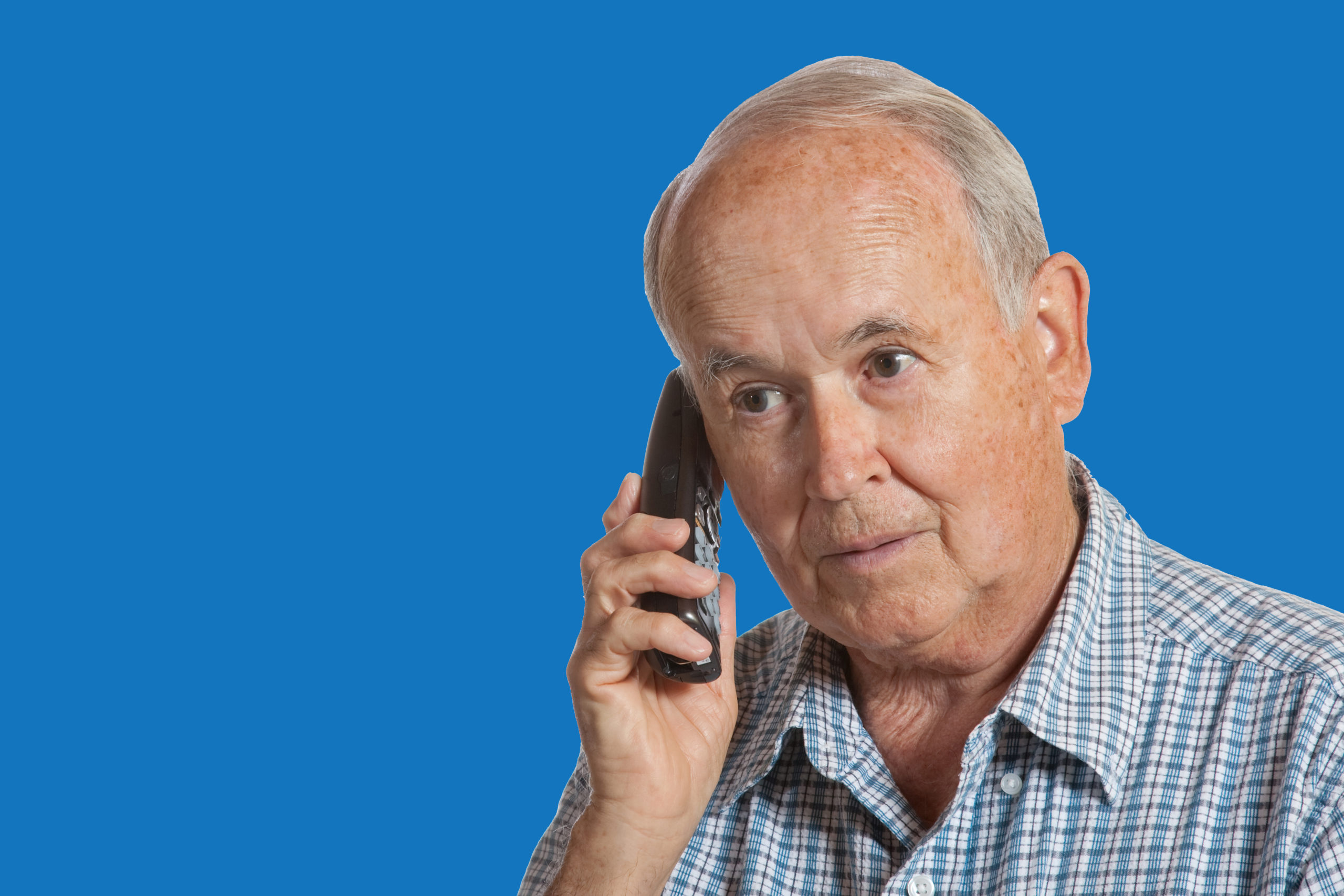 Elderly male talking on the telephone