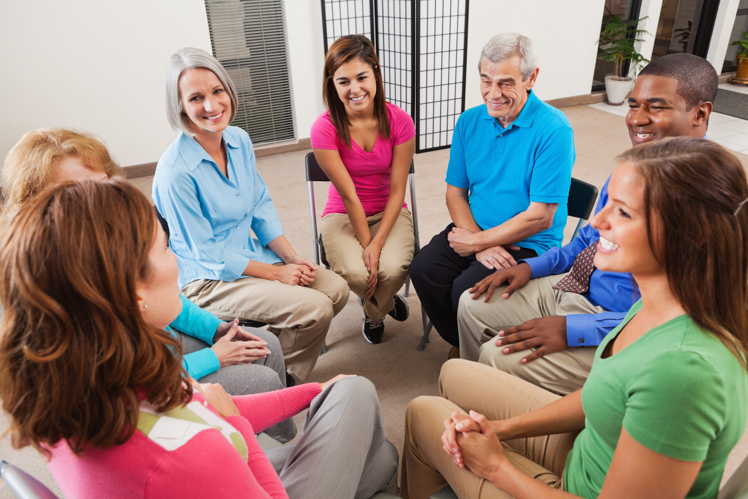 Diverse support group listening to friend tell story during discussion